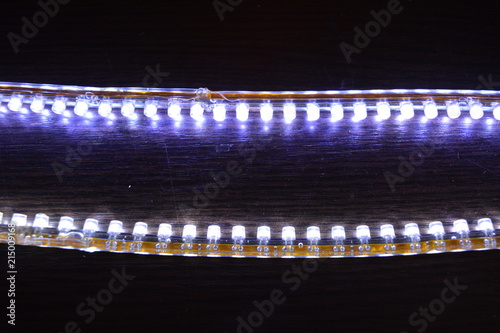 Bright glowing two LED stripes DIP in silicone included and glowing on a wooden background