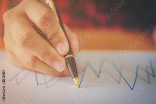 Businessman working with sheet analysis charts.