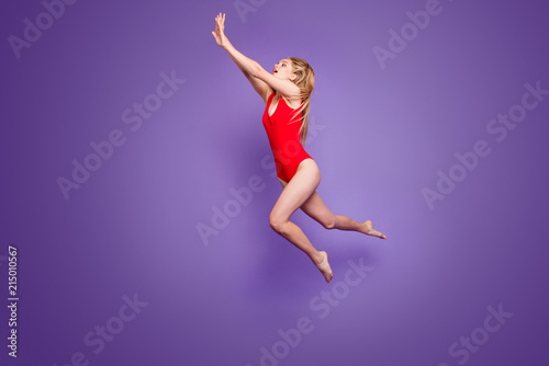 Summer time! People person hobby emotion expressing concept. Full length size studio photo portrait of beautiful excited funny fancy funky lady swimming under water isolated bright purple background