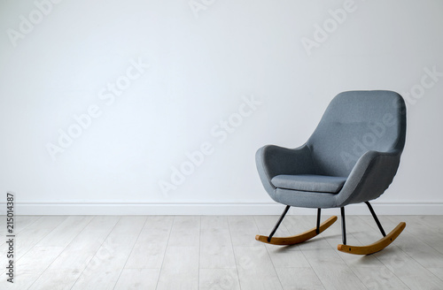 Stylish comfortable armchair near light wall indoors
