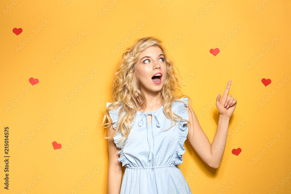 Emotional stylish young woman on color background