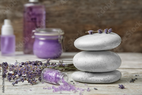Fototapeta Naklejka Na Ścianę i Meble -  Composition with lavender flowers, spa stones and natural cosmetic on table