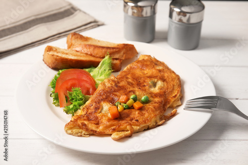 Omelet with vegetables on plate served for breakfast
