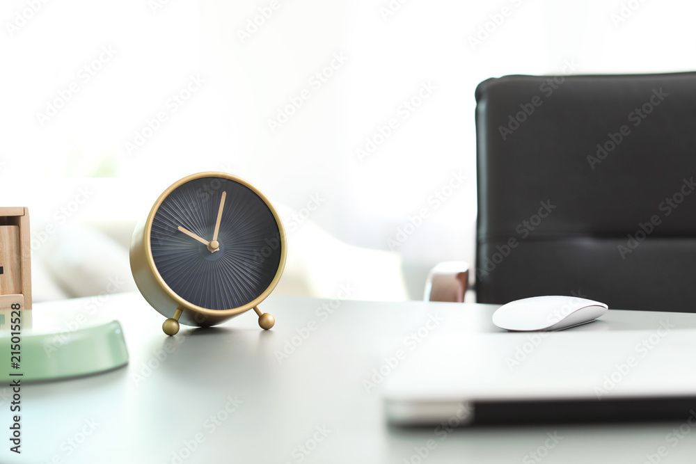 Stylish alarm clock on table in office. Time to work Stylish alarm clock on table in office. Time to work