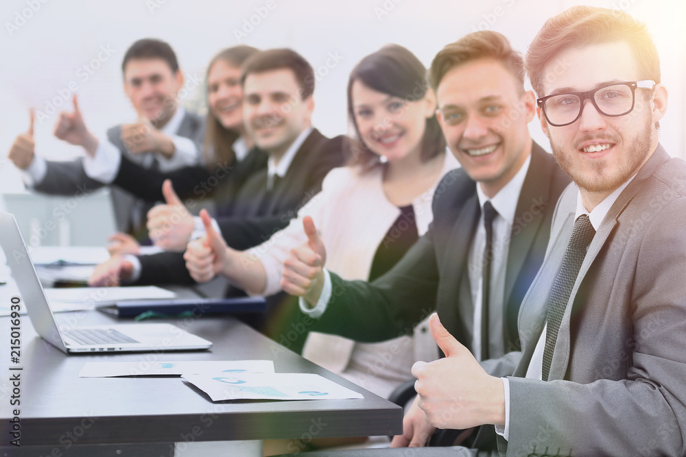 business team with thumbs up while sitting at his Desk business team with thumbs up while sitting at his Desk