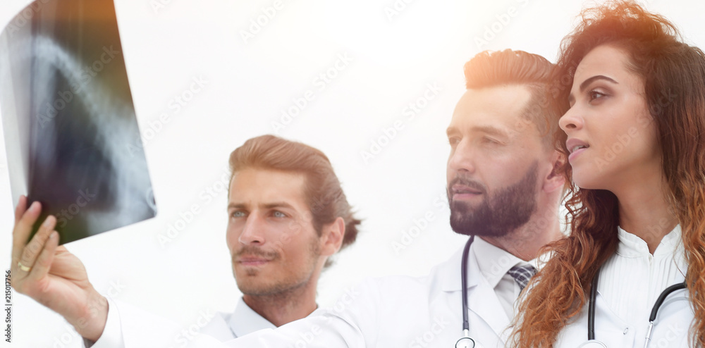 Fototapeta premium Portrait of young male doctors looking at x-ray