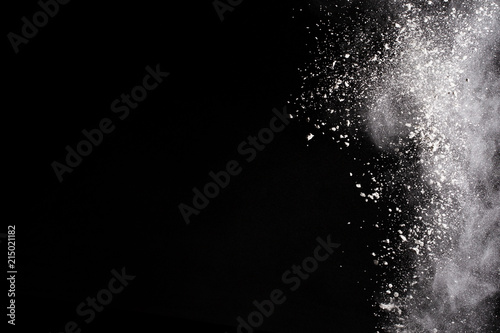 Launched white powder  isolated on black background.