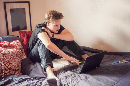 фотографія College student studying in his room