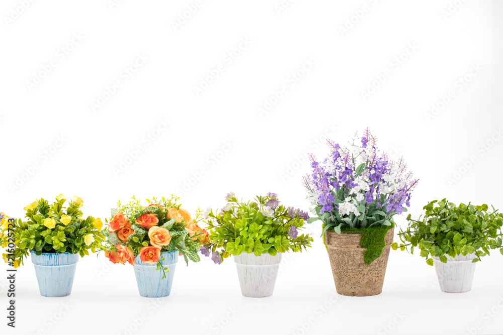 Rows of colorful fake flowers on white background, made from cloth and plastic for decoration