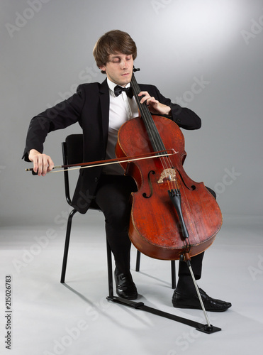 Portrait of the cellist on a light background.