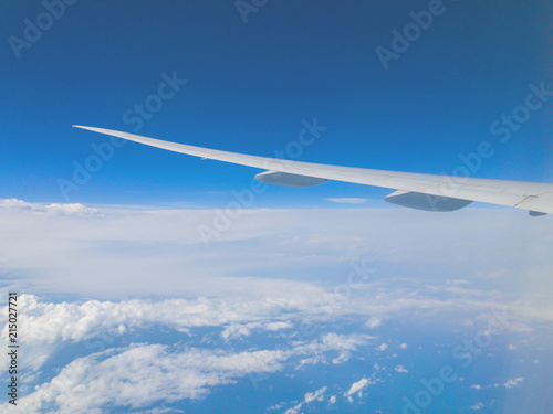 Airplane wing as seen from the passenger's seat. © astrosystem