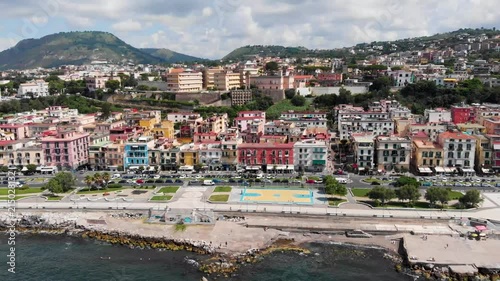 Aerial View Of Pozzuoli by the sea. Drone pulling back