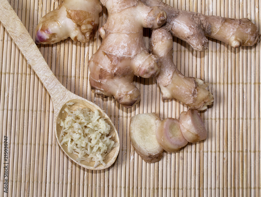 Fresh ginger root and spoon with grated ginger. A healthy product, for colds and for losing weight. Natural medicine.