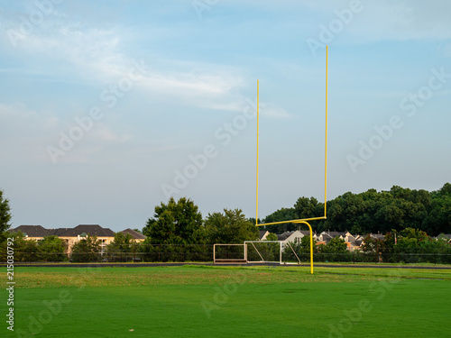 Football goal post at a high school field in the evening sun 