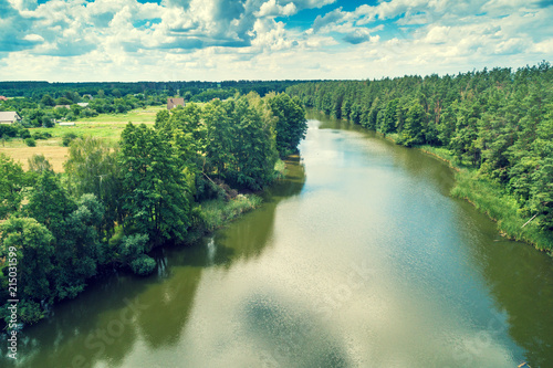 Aerial view of the countryside and river. Forest along the river