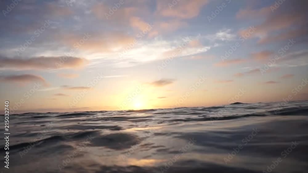 Calming ocean video with the sun setting in the background.