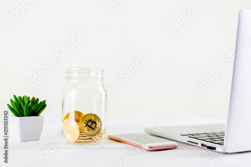 Bitcoin coin golden coin in the glass jar on wooden table ,stack of cryptocurrencies bitcoin isolated on white background,Bitcoin coin golden coin.Set of cryptocurrencies with a golden bitcoin photo