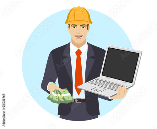 Businessman in construction helmet with money holding laptop notebook