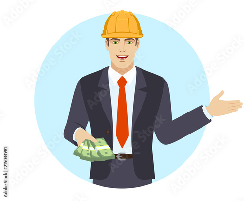 Welcome! Businessman in construction helmet with money showing something beside of him