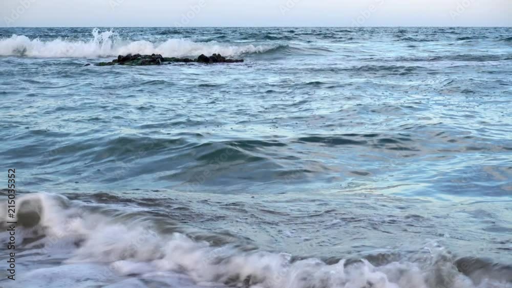 4K view of sea waves passes through a sandy beach. 4K view of sea waves passes through a sandy beach.