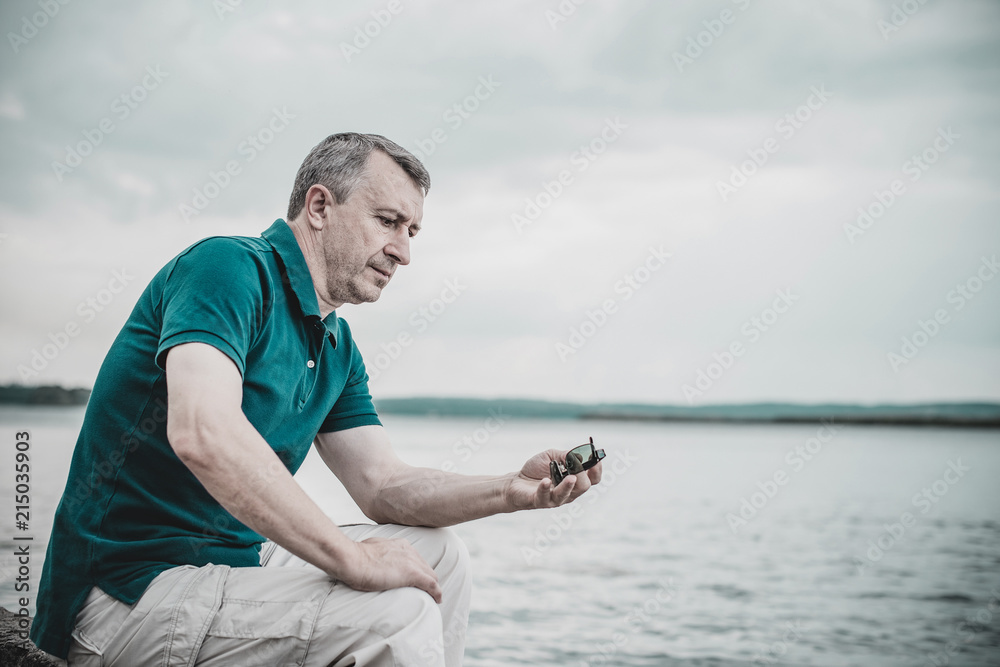 Contrast image of a sad mature man useful to illustrate stress, depression and alone sadness 