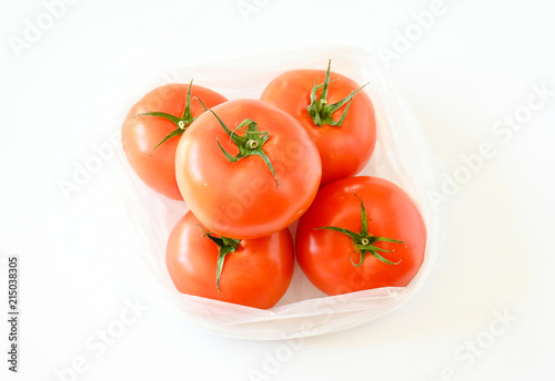 Freshness top view of tomatoes put in plastic bag on white background and vegetable full with nutrition and vitamin use in food and softdrink, commecial concept. photo