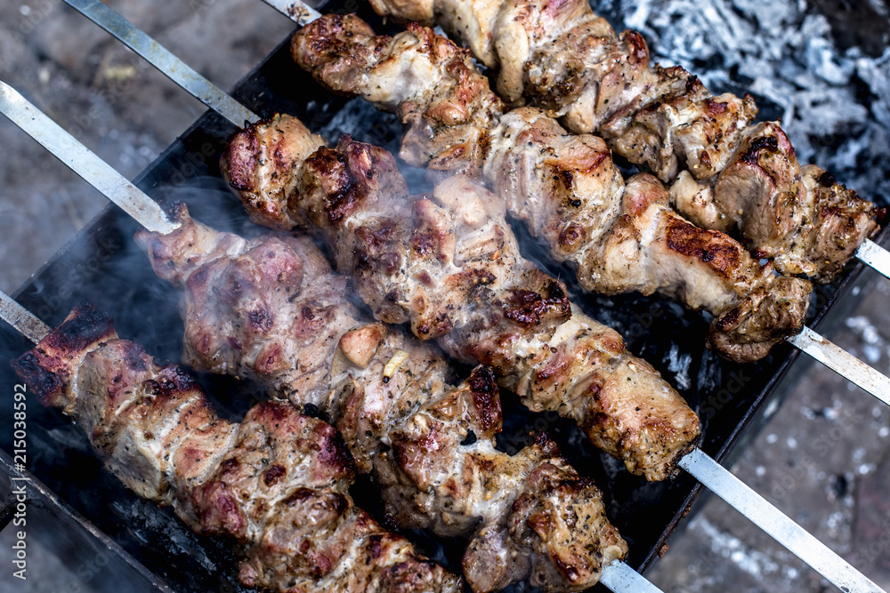 Grilled kebab cooking on metal skewers (grill).