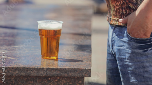 Beer in a plastic glass in the city photo