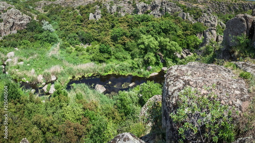 River in Aktovsky canyon, Ukraine. Big rocks in small river and calm water