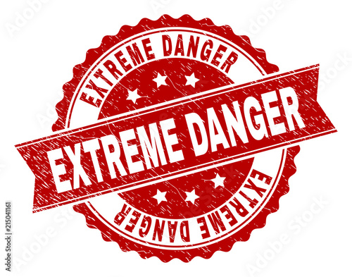 EXTREME DANGER seal print with distress texture. Rubber seal imitation has circle medallion form and contains ribbon. Red vector rubber print of EXTREME DANGER text with unclean texture.