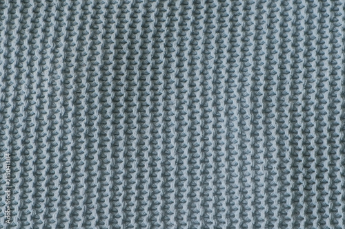 Dark green texture of the knitted fabric Vertical view.