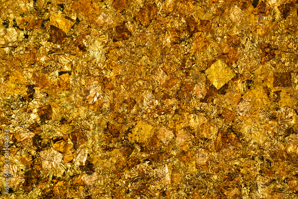 Shiny yellow gold leaf or scraps of gold foil background texture, surface from Back of Buddha image. Shiny yellow gold leaf or scraps of gold foil background texture, surface from Back of Buddha image.