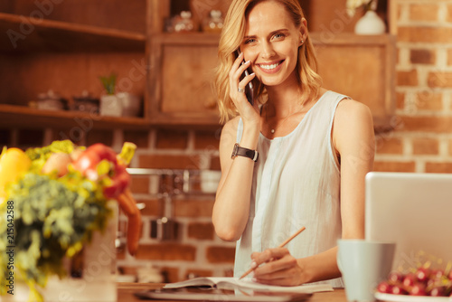 Wallpaper Mural Just smile. Amazing girl keeping smile on her face and making notes while looking straight at camera Torontodigital.ca