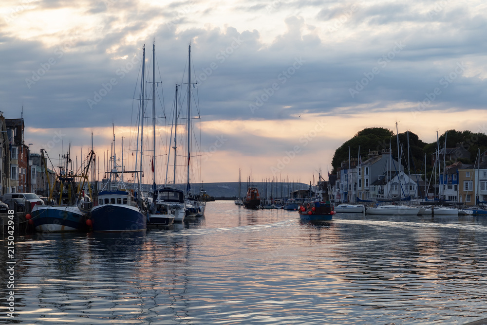 Dawn sunrise at Weymouth Old Harbour on a warm summer's day
