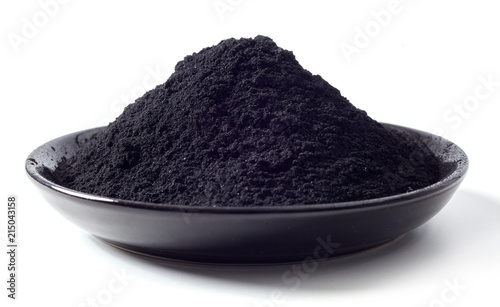 Dish heaped with food grade pulverised charcoal photo