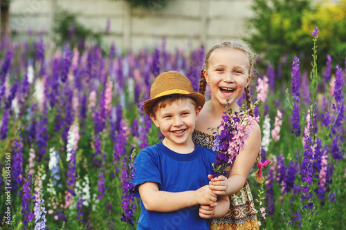 Fun and friendly children in a field of flowers