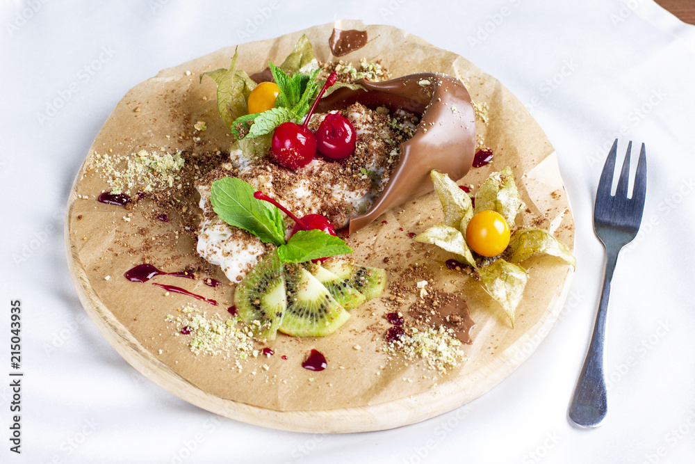 Chocolate dessert Mother's plant with cream and fresh fruits on round board Chocolate dessert Mother's plant with cream and fresh fruits on round board
