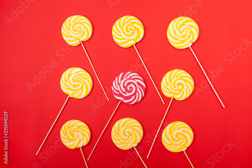 Obraz na plátne Sweet caramel candy on a red background