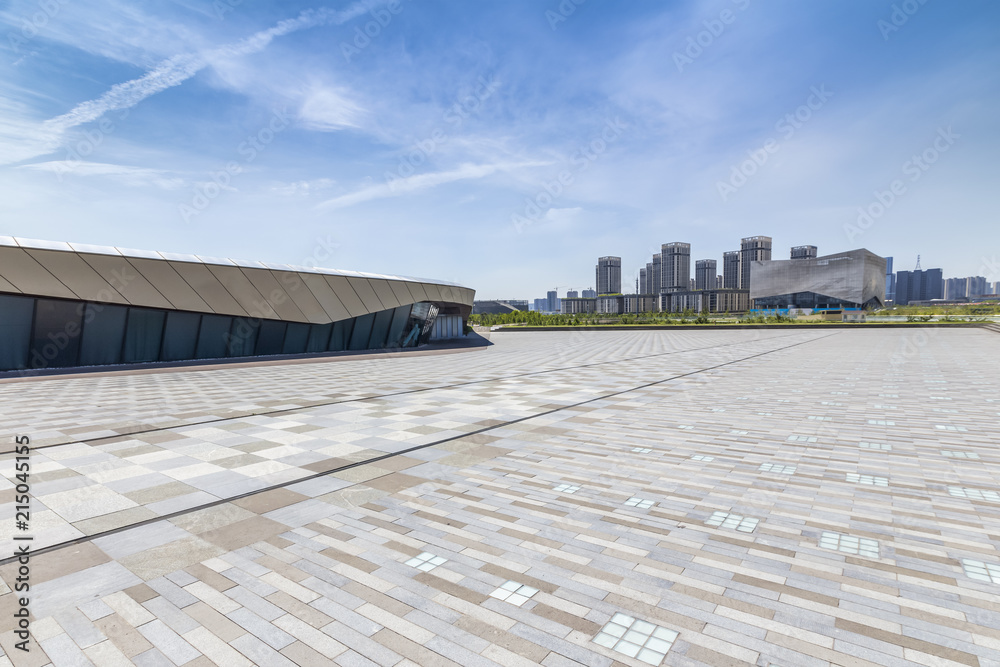 Panoramic skyline and modern business office buildings with empty road,empty concrete square floor Panoramic skyline and modern business office buildings with empty road,empty concrete square floor
