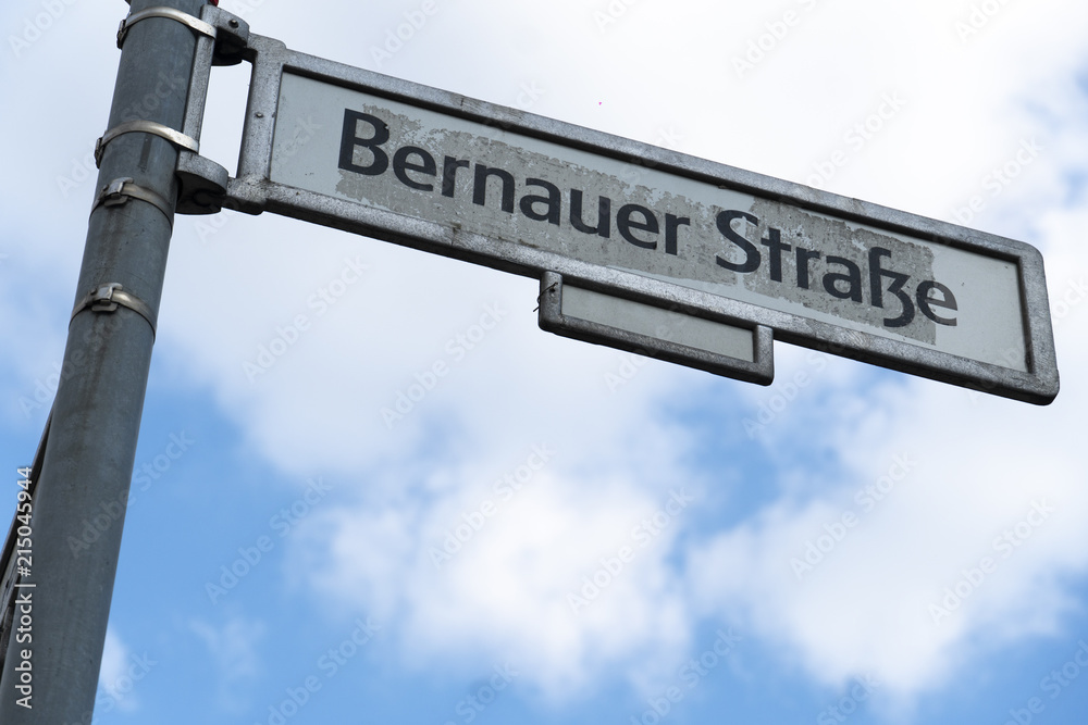 Fototapeta premium Bernauer Strasse street name sign in Berlin, Germany. Situated between the localities of Gesundbrunnen and Mitte, Bernauer Straße runs from Mauerpark at the corner of Prenzlauer Berg