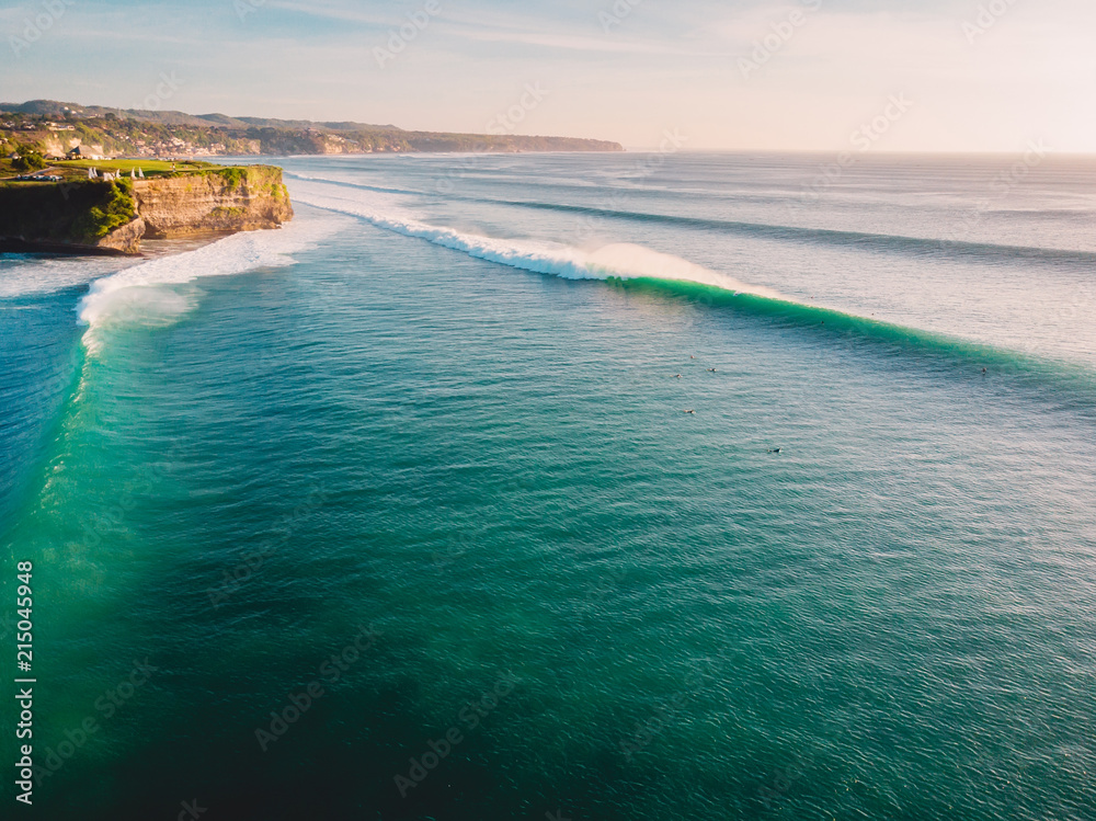 Aerial shooting of big waves at sunset. Biggest ocean waves in Bali and coastline