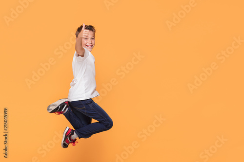Little boy jumping in the studio, smiling.