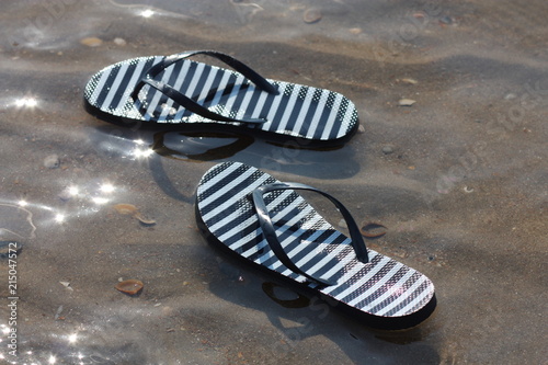Flip flops in the sea. Holiday feeling.