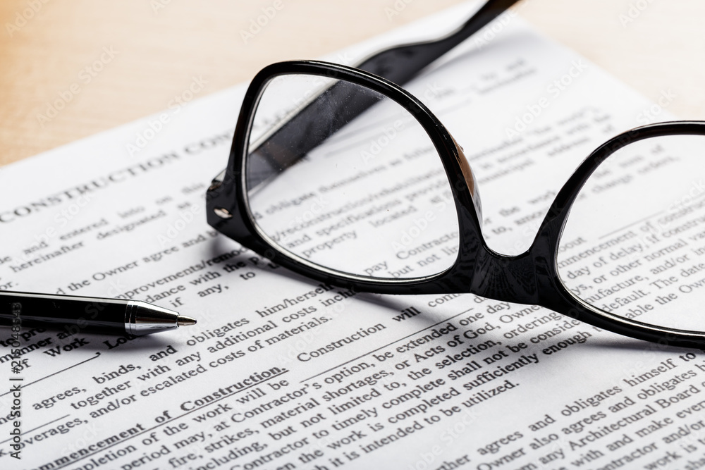 Close up shot of Eyeglasses on document papers business concept Close up shot of Eyeglasses on document papers business concept
