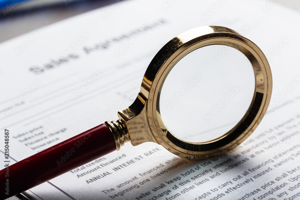 Magnifying Glass and document close up Magnifying Glass and document close up