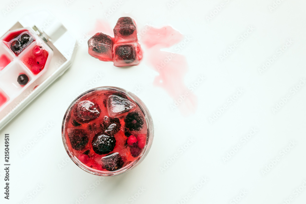 Cocktail of berries frozen in ice cubes (raspberries, blackberries , red and black currants) . Summer cold refreshing drink. Selective focus.Copy space. Cocktail of berries frozen in ice cubes (raspberries, blackberries , red and black currants) . Summer cold refreshing drink. Selective focus.Copy space.