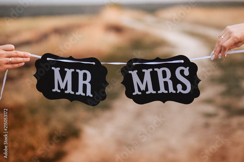 Funny bride and groom with Mr and Mrs signs. Happy wedding day