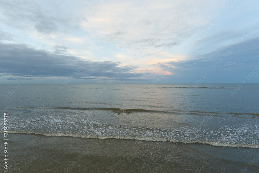 Inspirational of sea and sky background. Soft waves on sandy beach. Sunset landscape