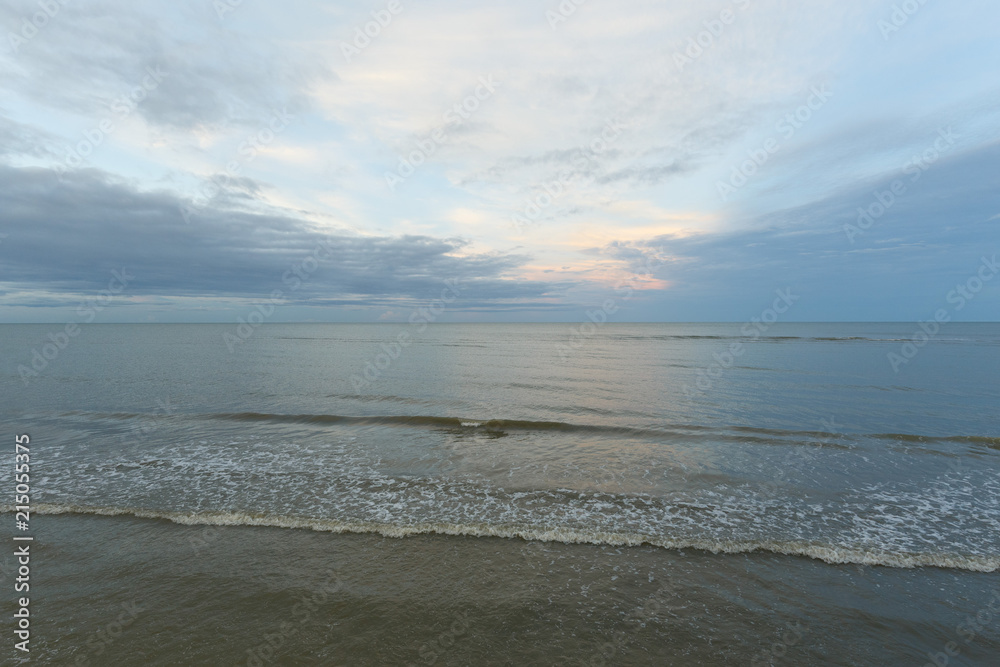 Inspirational of sea and sky background. Soft waves on sandy beach. Sunset landscape Inspirational of sea and sky background. Soft waves on sandy beach. Sunset landscape