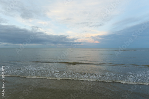 Inspirational of sea and sky background. Soft waves on sandy beach. Sunset landscape